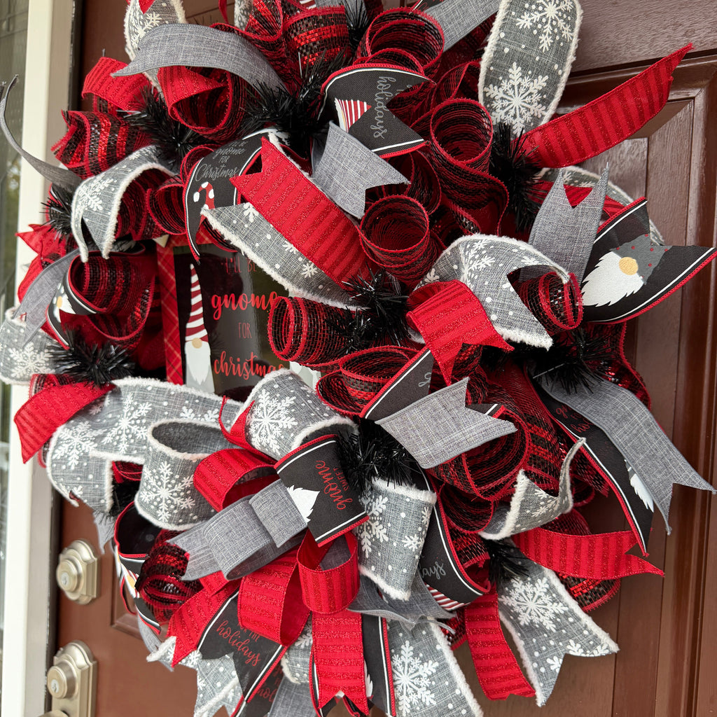 Handmade Christmas gnome deco mesh wreath with red, black, and gray snowflake ribbons and I'll Be Gnome for Christmas sign.