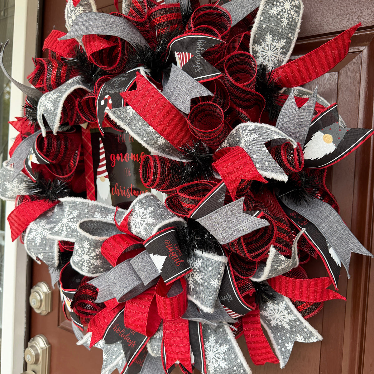 Handmade Christmas gnome deco mesh wreath with red, black, and gray snowflake ribbons and I'll Be Gnome for Christmas sign.
