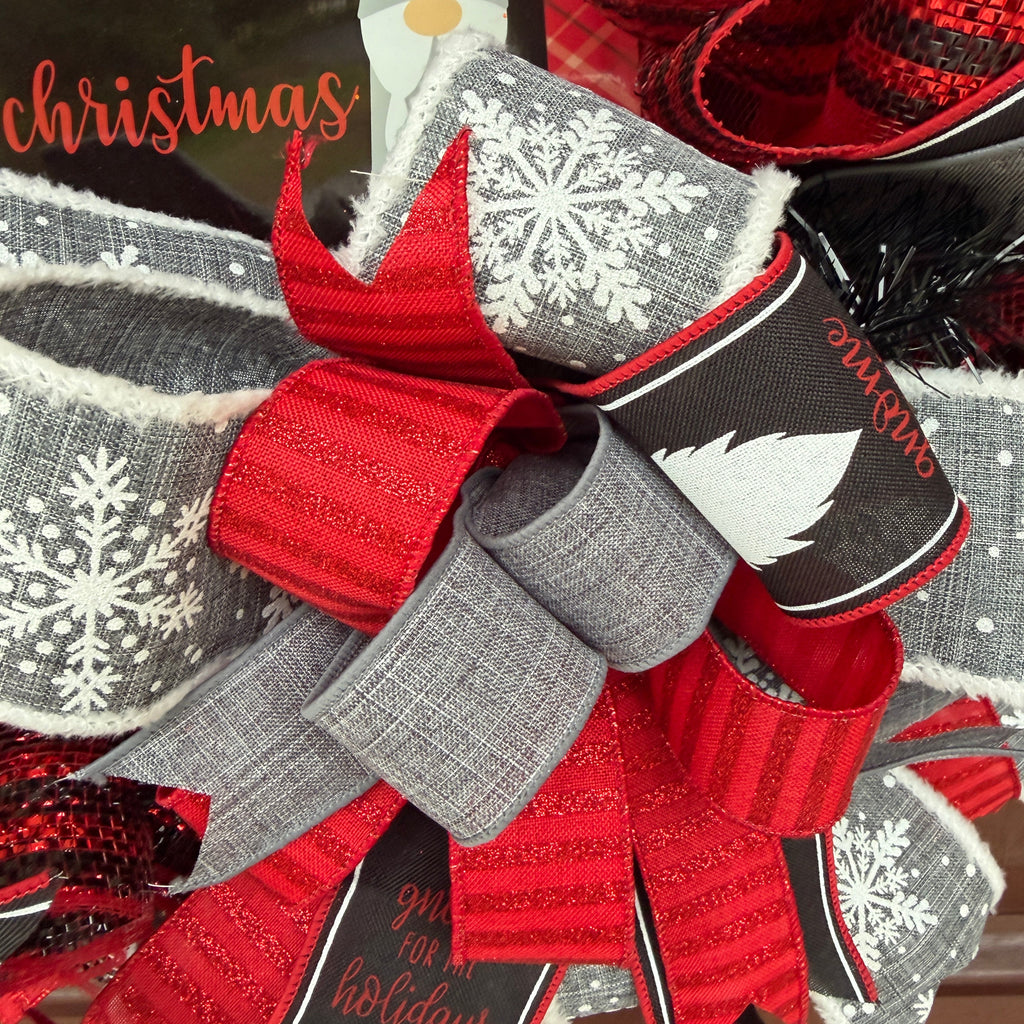 Handmade Christmas gnome deco mesh wreath with red, black, and gray snowflake ribbons and I'll Be Gnome for Christmas sign.
