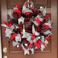 Handmade Christmas gnome deco mesh wreath with red, black, and gray snowflake ribbons and I'll Be Gnome for Christmas sign.