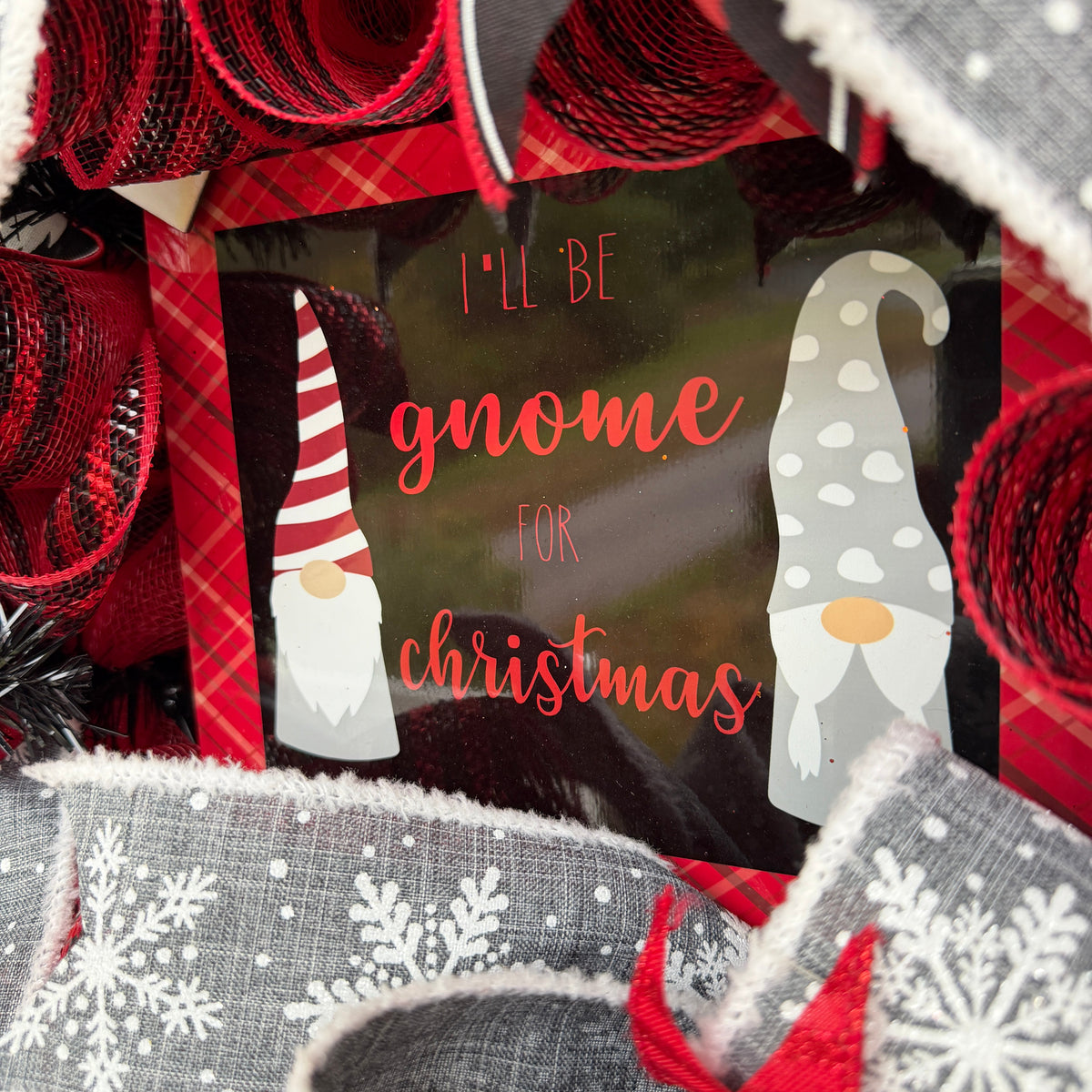 Handmade Christmas gnome deco mesh wreath with red, black, and gray snowflake ribbons and I'll Be Gnome for Christmas sign.