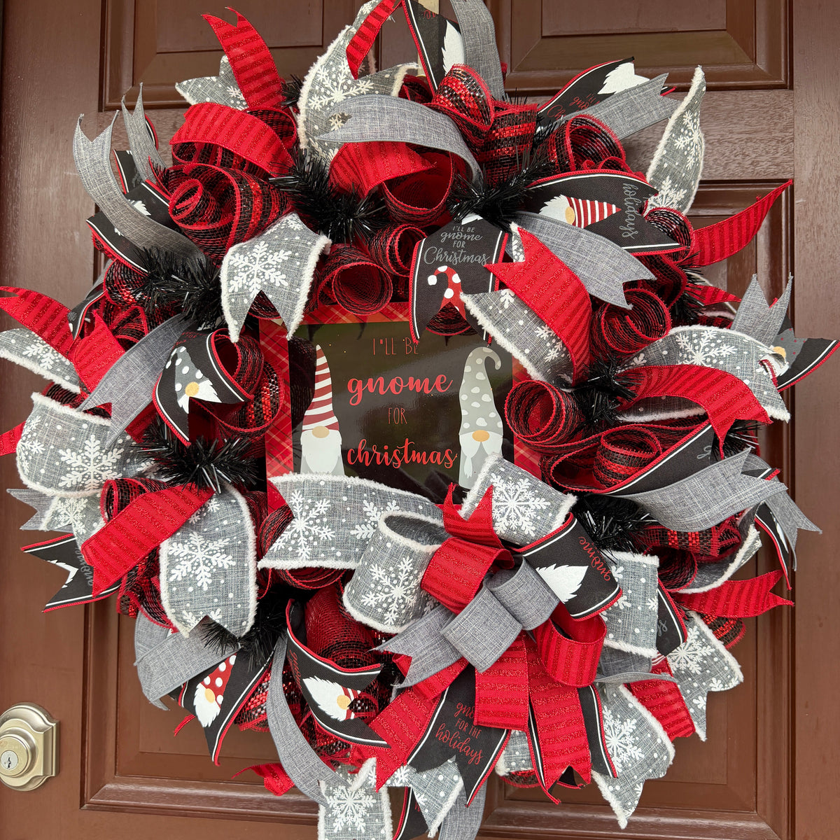 Handmade Christmas gnome deco mesh wreath with red, black, and gray snowflake ribbons and I'll Be Gnome for Christmas sign.