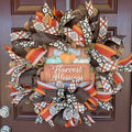 Harvest Blessings wreath. Rich pumpkin orange, deep brown, cream, and soft green come together in a full, layered design that feels cozy, cheerful, and perfect for the season.