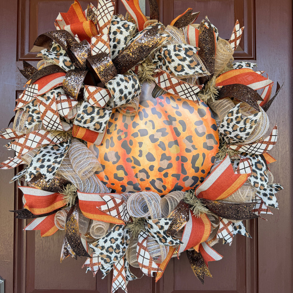 Make your front door feel bold, warm, and a little unexpected this fall with this playful leopard pumpkin wreath. Rich autumn orange, warm brown, cream, and black come together with animal-print accents for a look that feels festive without being ordinary.