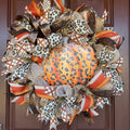 Make your front door feel bold, warm, and a little unexpected this fall with this playful leopard pumpkin wreath. Rich autumn orange, warm brown, cream, and black come together with animal-print accents for a look that feels festive without being ordinary.