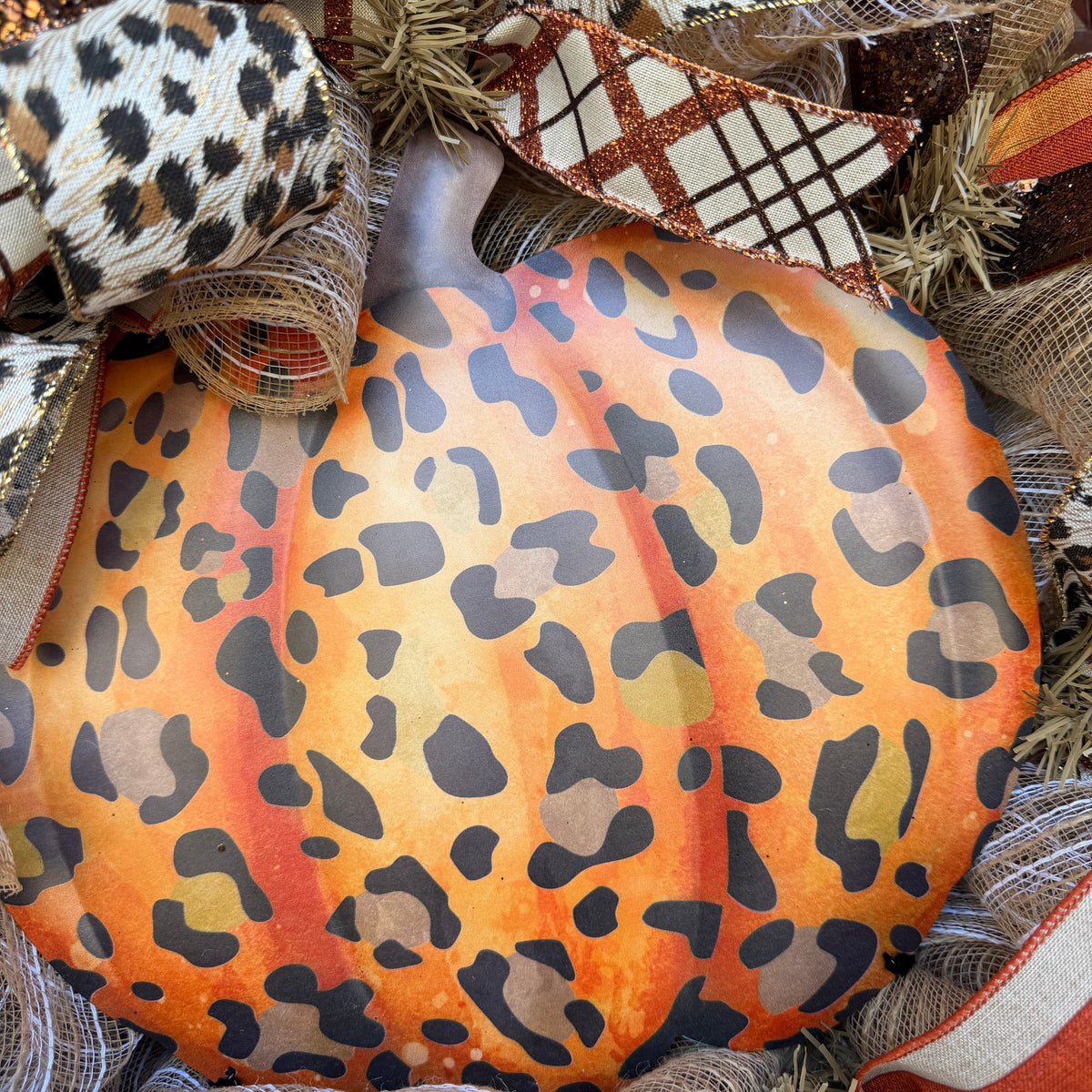 Make your front door feel bold, warm, and a little unexpected this fall with this playful leopard pumpkin wreath. Rich autumn orange, warm brown, cream, and black come together with animal-print accents for a look that feels festive without being ordinary.