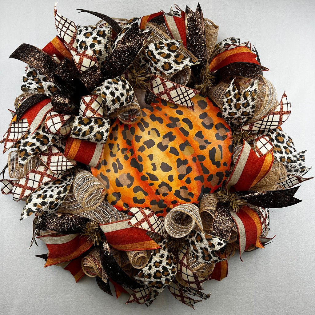 Make your front door feel bold, warm, and a little unexpected this fall with this playful leopard pumpkin wreath. Rich autumn orange, warm brown, cream, and black come together with animal-print accents for a look that feels festive without being ordinary.