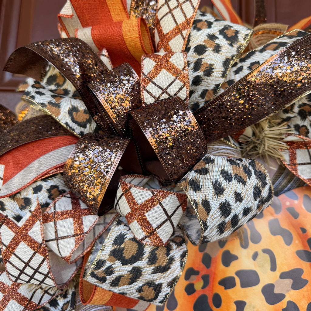 Make your front door feel bold, warm, and a little unexpected this fall with this playful leopard pumpkin wreath. Rich autumn orange, warm brown, cream, and black come together with animal-print accents for a look that feels festive without being ordinary.
