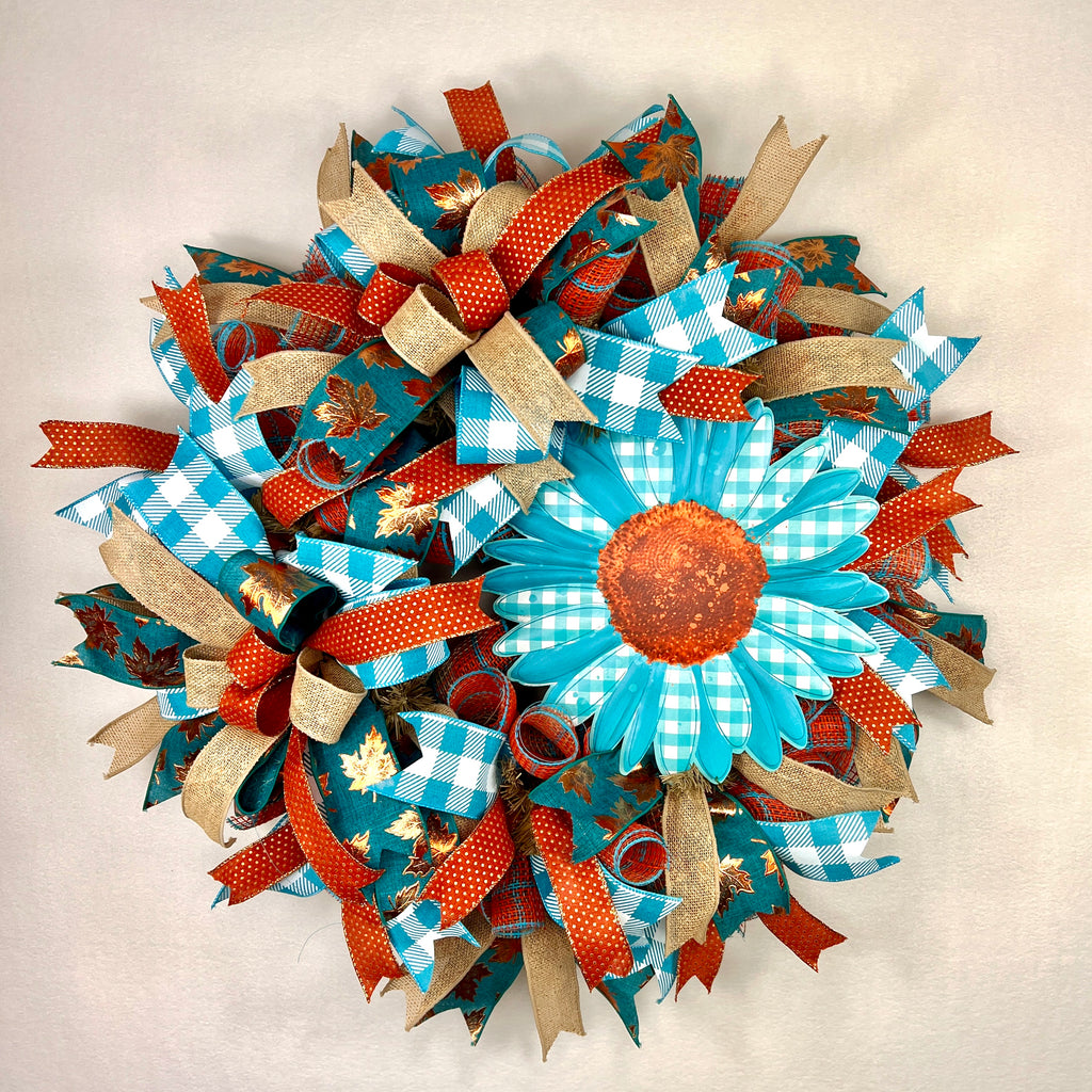 Teal sunflower fall wreath with orange, cream, and plaid ribbons.