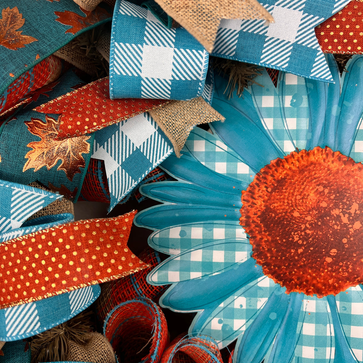 Teal sunflower fall wreath with orange, cream, and plaid ribbons.