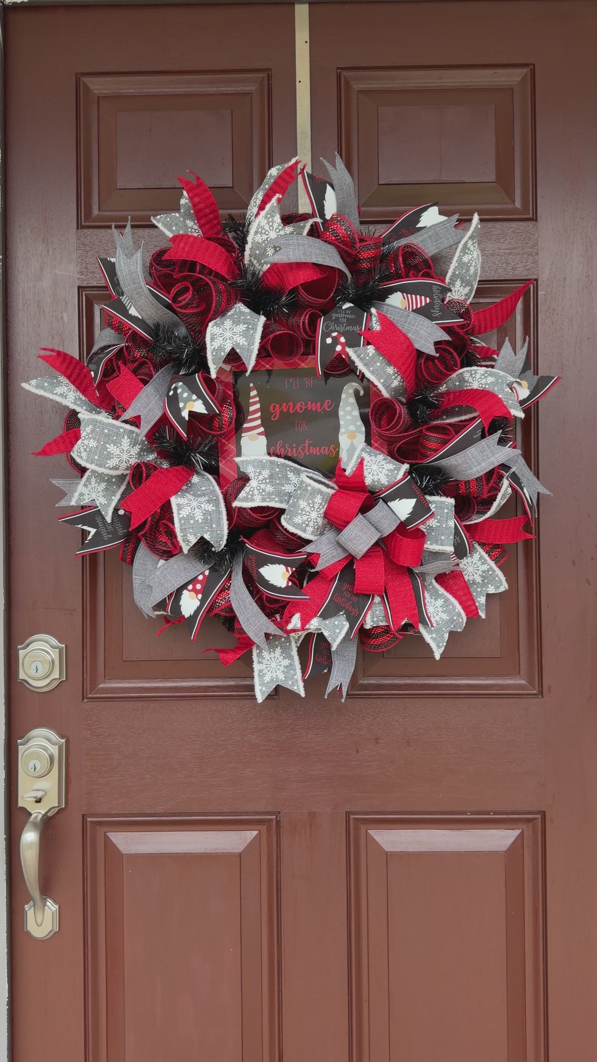 Handmade Christmas gnome deco mesh wreath with red, black, and gray snowflake ribbons and I'll Be Gnome for Christmas sign.