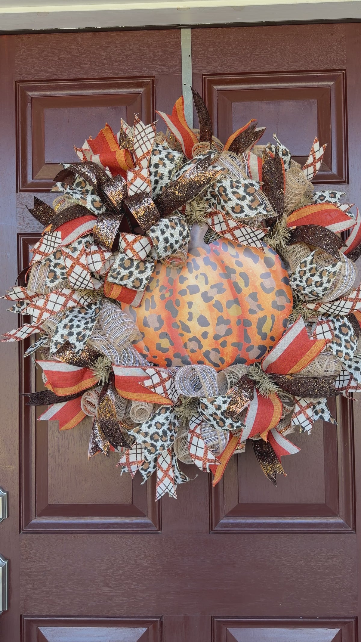 leopard pumpkin wreath. Rich autumn orange, warm brown, cream, and black come together with animal-print accents for a look that feels festive without being ordinary.